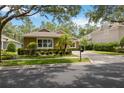 Inviting single-story home with manicured landscaping, lush green lawn, and mature trees for added privacy at 207 Spalding Way, Deland, FL 32724