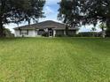 Charming single-story home featuring a well-manicured lawn and mature trees enhancing curb appeal at 23717 Milford Dr, Eustis, FL 32736
