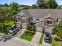 Aerial view of townhouses, manicured lawns, attached garages, and ample parking at 2420 Stockton Dr, Sanford, FL 32771