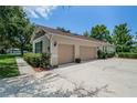Spacious two-car garage with ample driveway space and tasteful exterior finishes at 2426 Breezy Meadow Rd, Apopka, FL 32712