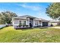Attractive single-story home featuring manicured landscaping, updated paint, and an attached two-car garage at 2919 Foraker Way, Kissimmee, FL 34758
