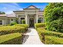 Charming front entrance with elegant pillars, manicured hedges, and an inviting walkway at 307 Running Wind Ln, Maitland, FL 32751