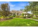 Inviting single-story home with a lush green lawn and mature trees, showcasing curb appeal at 307 Running Wind Ln, Maitland, FL 32751