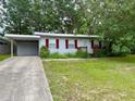 Cozy single-story home with a carport and mature trees at 31538 Anderson Dr, Tavares, FL 32778