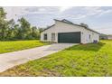 Contemporary home featuring a modern architectural design, well-maintained lawn, and a paved driveway at 3832 Sw 157Th Place Rd, Ocala, FL 34473
