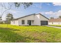 A modern home featuring clean lines, a well manicured lawn, and an attached two car garage at 3832 Sw 157Th Place Rd, Ocala, FL 34473