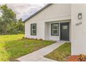 Charming home featuring a well-manicured lawn, inviting walkway, and modern exterior paint at 3832 Sw 157Th Place Rd, Ocala, FL 34473