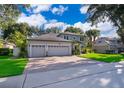Elegant home boasting a three-car garage, paved driveway, and lush green lawn at 394 Baymoor Way, Lake Mary, FL 32746