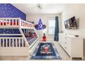 Whimsical bedroom featuring a bunk bed, TV, and star-themed decor at 421 Southfield St, Kissimmee, FL 34747