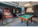 Spacious game room with Star Wars themed decor, pool table, basketball hoop and custom flooring at 421 Southfield St, Kissimmee, FL 34747