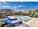 Relaxing backyard oasis with a private pool, lounge chairs, and lush landscaping at 421 Southfield St, Kissimmee, FL 34747