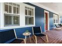 Inviting front porch seating area with chairs and a table offering a relaxed outdoor space at 4310 Ethan Lane Ln, Orlando, FL 32814