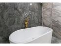 Elegant bathroom featuring a freestanding tub, gold fixtures, and stylish tile work at 6019 Crystal View Dr, Orlando, FL 32819