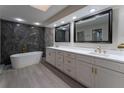 Bathroom featuring a modern vanity with dual sinks and a luxurious freestanding tub at 6019 Crystal View Dr, Orlando, FL 32819