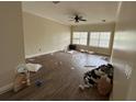 Spacious living room with wood-look flooring, abundant natural light, and a ceiling fan at 6230 Cranberry Dr, Port Orange, FL 32127