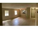 Spacious living room featuring tile flooring, natural light from windows, and neutral paint at 7266 Oak Meadows Cir, Orlando, FL 32835