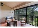 Inviting screened-in porch featuring comfortable seating and views of lush greenery at 7742 Sugar Bend Dr # 7742, Orlando, FL 32819
