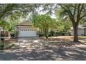 Charming single-Gathering home with a two-car garage, mature trees, and a well-maintained lawn at 7924 Bridgestone Dr, Orlando, FL 32835
