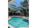 Sparkling pool and spa featuring an inviting screened enclosure for year-round enjoyment at 7924 Bridgestone Dr, Orlando, FL 32835