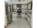 Kitchen with stainless steel refrigerator and white cabinets at 826 Horseshoe Bay Dr, Kissimmee, FL 34741