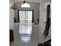 Bright living room with tiled floors and sliding glass doors to the backyard at 826 Horseshoe Bay Dr, Kissimmee, FL 34741