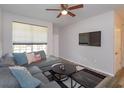 Modern living room showcasing a comfortable gray sectional, a contemporary rug, and a mounted flat-screen television at 835 Grand Regency Pt # 104, Altamonte Springs, FL 32714