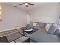 Inviting living room with a comfortable gray sectional sofa, stylish rug, and a ceiling fan for added comfort at 835 Grand Regency Pt # 104, Altamonte Springs, FL 32714