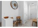 Bright entryway with tile flooring, stylish decor, and a coat closet at 9591 Amber Chestnut Way, Winter Garden, FL 34787
