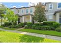 Charming townhouse with well-manicured landscaping and a sidewalk leading to the entrance at 9591 Amber Chestnut Way, Winter Garden, FL 34787