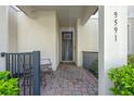 Inviting covered front porch with brick pavers, seating, and decorative railings at 9591 Amber Chestnut Way, Winter Garden, FL 34787