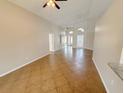 Bright and spacious living room with tile flooring, high ceilings, and ample natural light at 14014 Spruce Creek Ln, Orlando, FL 32828