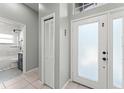 Welcoming foyer features tiled flooring, closet and bathroom access with plenty of natural light at 10064 River Glen Ct, Orlando, FL 32825