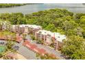 Aerial view of condo complex near a beautiful lake and lush greenery at 1166 Carmel Cir # 120, Casselberry, FL 32707