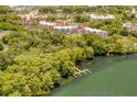 Aerial shot of condos nestled among trees with a lake and dock at 1166 Carmel Cir # 120, Casselberry, FL 32707