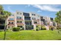 Condo building with screened-in patios and well-maintained green lawn at 1166 Carmel Cir # 120, Casselberry, FL 32707