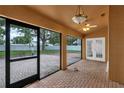 Screened-in patio with brick flooring and view of fenced backyard, perfect for outdoor living at 12713 Pine Arbor Dr, Clermont, FL 34711