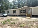 Well-maintained exterior showcasing a cozy single-story home with a clean aesthetic at 1349 Nw 109 Ave, Ocala, FL 34482