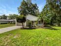 Inviting single-story home with a cozy front porch and mature landscaping at 142 E 9Th St, Chuluota, FL 32766