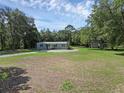 Expansive front yard view showcasing the single-story home, mature trees, and well-maintained lawn at 18166 Lynbrook Rd, Orlando, FL 32820