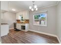 Charming kitchen with white cabinets, granite countertops, and stainless steel appliances at 220 Colony Pl, Casselberry, FL 32707