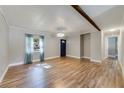 Bright living room with wood floors, modern light fixture, and large front window at 220 Colony Pl, Casselberry, FL 32707