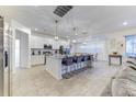 Modern kitchen featuring a center island with seating, stainless steel appliances, and white cabinetry at 2537 Shanti Dr, Kissimmee, FL 34746