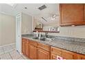 Kitchen featuring wood cabinets and an open view to the living area at 2753 Beckwith St, Deltona, FL 32738