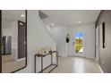 Bright entryway with tile flooring, a console table, and a view to the front door at 3304 Wye Oak Dr, Apopka, FL 32703