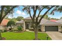 Charming single-story home featuring lush landscaping, a two-car garage, and a meticulously maintained front yard at 387 Devon Pl, Lake Mary, FL 32746