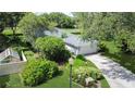 Aerial view of a lovely home with lush landscaping and a backyard oasis, showcasing the property's serene setting at 42 W Grenewood Ln, Haines City, FL 33844