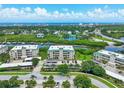 Beautiful aerial view of condo building, lake, and ocean in the distance on a sunny day at 426 Bouchelle Dr # 202, New Smyrna Beach, FL 32169
