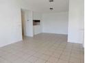 Spacious living area featuring tile flooring, neutral walls, and ample natural light at 5220 Via Hacienda # 212, Orlando, FL 32839