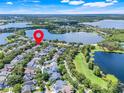 Stunning aerial view showcasing the neighborhood's prime location near a large lake at 5263 Beach River Road, Windermere, FL 34786