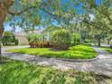 Charming green home featuring a lush landscaped yard and beautiful surroundings at 5263 Beach River Road, Windermere, FL 34786